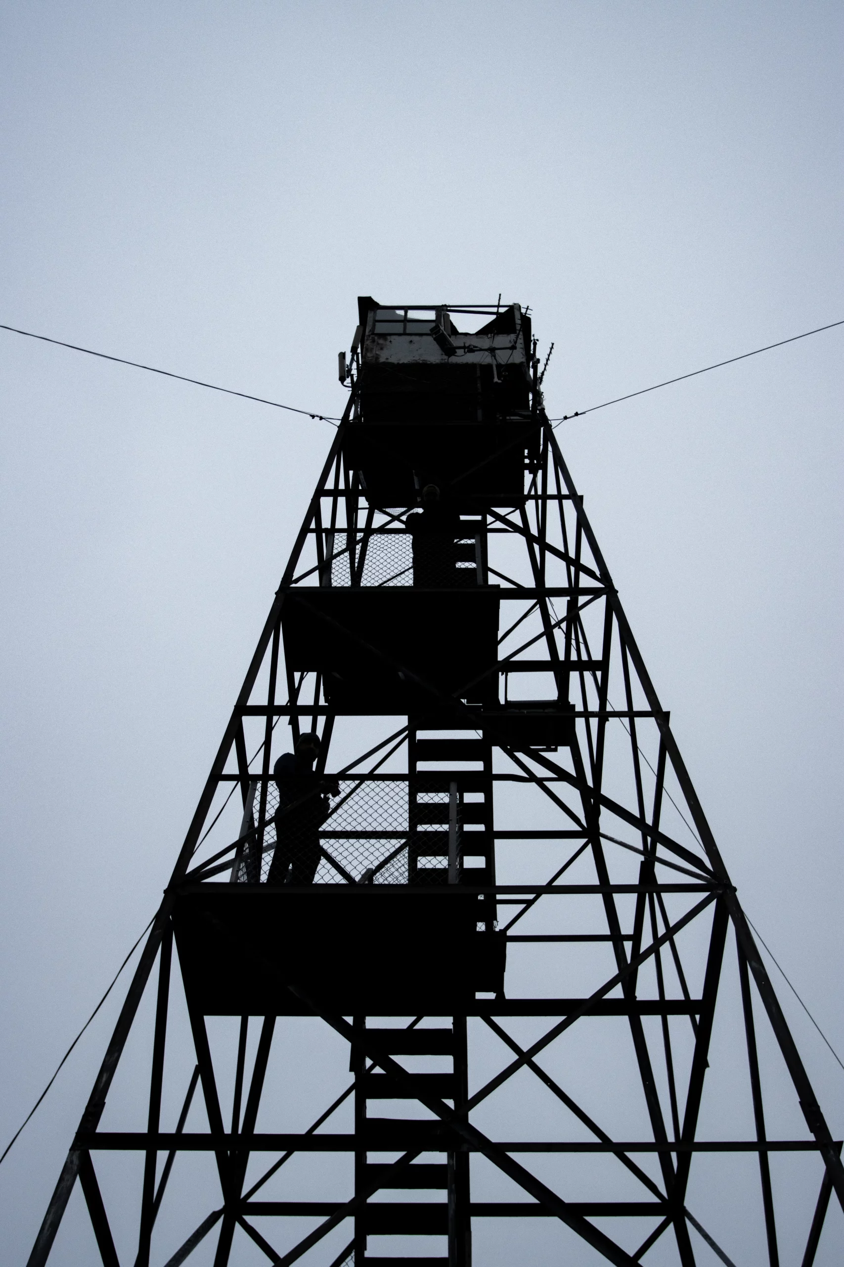 The Goodnow Tower silhouetted against a grey sky.