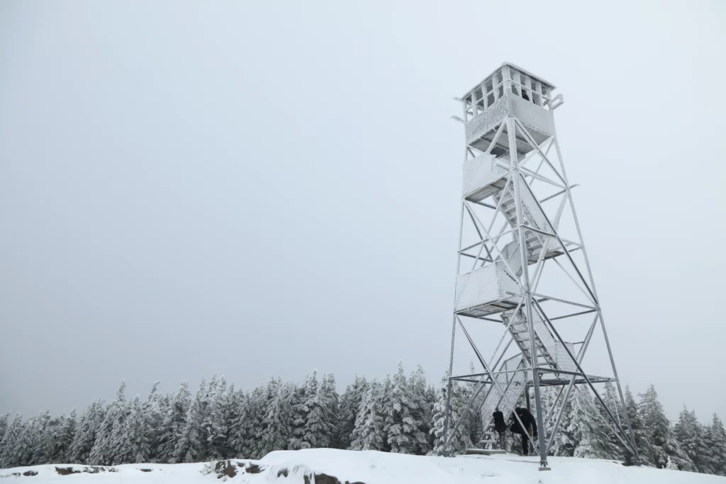 Justin perches up under the tower while everyone adds on a few layers.