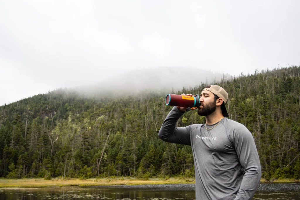 Kevin drinking purified water from his Grayl.